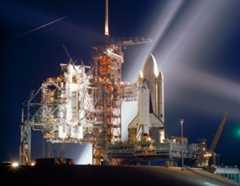 The space shuttle Columbia, NASA's first orbiter, is showered with lights in this nocturnal scene at Launch Pad 39A at the Kennedy Space Center in Cape Canaveral, Fla., during preparations for the first flight (STS-1) of NASA's new reusable spacecraft sys