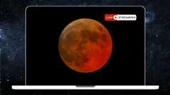 An image of a laptop displaying a picture of an orange full moon against a black sky, with the words 'live streaming' positioned in the upper right of the screen. A starry deep space scene is visible in the background behind the laptop.