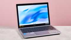 Acer Chromebook Spin 312 open on desk with pink background