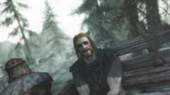 Ralof sitting in a prisoner wagon chatting to the Dragonborn during the opening of Skyrim.