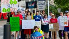 A series of images from the recent NASA protests showing various individuals holding microphones and signs outside of NASA's D.C. headquarters with the red lettering logo in front of glass doors