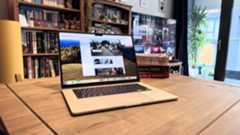 The 2024 MacBook Air M3 on a wooden table in front of a bookshelf.