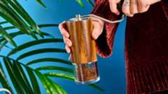 the comandante c40 mk4 hand coffee grinder with a glass catch chamber and high nitrogen steel burrs