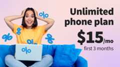 Woman holding head on blue sofa with laptop