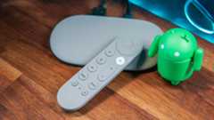 Google TV Streamer with Android figure and remote