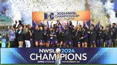 Orlando Pride players raise the trophy during the NWSL Championship game between Orlando Pride and Washington Spirit at CPKC Stadium on November 23, 2024 in Kansas City, Missouri.