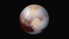 Pluto with patches of rusty brown and sandy yellow on the surface.