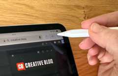 Hand holding Apple Pencil over iPad Pro