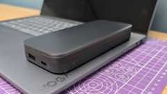 Lenovo Go USB-C laptop power bank sitting on a Yoga Slim 7i laptop to show the size