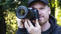 Panasonic Lumix S1 II mirrorless camera held up to photographer&#039;s eye