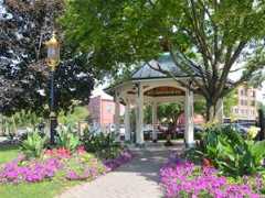 pavilion protecting hathorn spring one with lots of colorful flowers and trees surrounding it