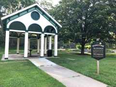 large white pavilion that protects governor and peerless springs with informational sign