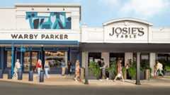 People walking in front of a two store fronts