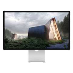 Mac display showing photo of ultra-modern, triangular cabins in a green forest with grey clouds overhead