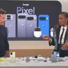 Two people discussing Google Pixel smartphones and accessories at a tech display event.