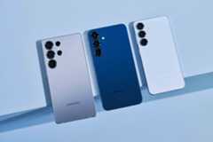 Three Samsung smartphones are shown in silver, blue, and white colors with triple camera setups aligned vertically.