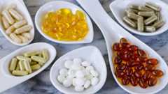 Vitamin capsules in spoons