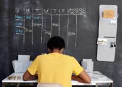 Student working at a desk, learning remotely.