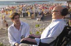 Former actor Christopher Reeve and his son Matthew talk on the promenade overlooking the Mediterranean Sea, August 1, 2003 in Tel Aviv, Israel. Reeve is on a four-day visit to Israel.  (Photo by Israel Hadari-Pool/Getty Images)