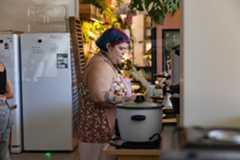 An employee prepares a box of sweets.