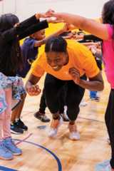 Morgahn Fingall interacts with young children who are happy and engaged in group play