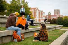 Students sit in the amphitheater hanging out between class