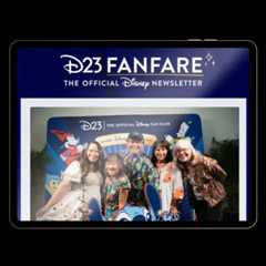 Hands holding a tablet, scrolling through D23 FanFare to get the latest Disney news.