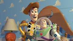 A promotional image for 1995’s Toy Story, featuring Sheriff Woody (voiced by Tom Hanks) and Buzz Lightyear (voiced by Disney Legend Tim Allen). They are in their iconic outfits and standing in Andy’s childhood bedroom.