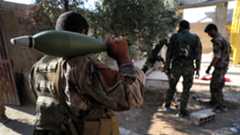 Syrian Democratic Forces fighters prepare to fire a mortar shell, in Raqqa, northeast Syria. (AFP)