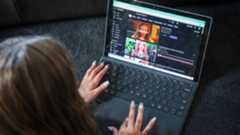 The photo shows a ten-year-old girl lying on the floor as she searches for a show on YouTube at her home in western Sydney. (AFP)
