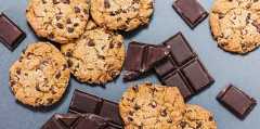 oatmeal chocolate cookies and pieces of chocolate bars scattered around.