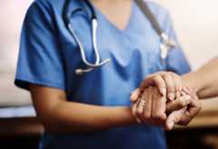 Cropped shot of an unrecognizable female nurse holding a senior womans hands in comfort.