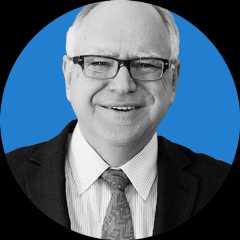Headshot of Minnesota Governor Tim Walz on a blue background.