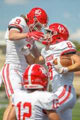 The football team celebrates on the field