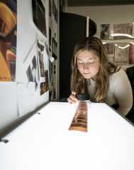 A student looks at film on a lightbox