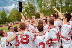 Men's Lacrosse team cheering on the field