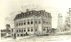 two-and-a-half-story stone building with mansard roof