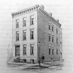 three-story brownstone building with ornamental cornice