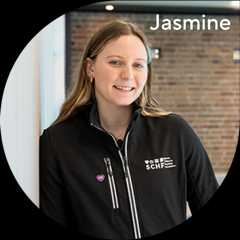 Jasmine Greenwood wearing a SCHF sweater standing in front of a swimming pool