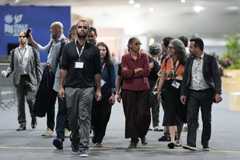Brazilian Minister of the Environment, Marina Silva, walks with delegates .