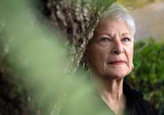 A close up photo of Lori Phillips near a tree