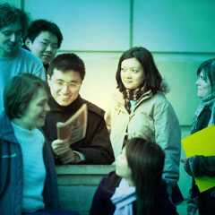 A group of undergraduate students outside a building, green tint over image.
