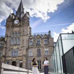 Two students walking outside the Edinburgh Futures Institute building