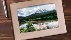 boxed set of greeting cards with a forest and mountain scene on the first card