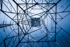 view upward through bottom of electricity transmission tower