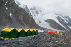 tents against a dark grey mountain background