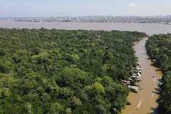 FILE PHOTO: A drone image shows the Amazon rainforest and the city of Belém in the back ahead of COP 30, at Ilha do Combu, in Belem