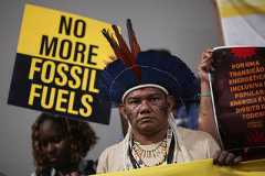 Activists and Indigenous people take part in a Stop EACOP campaign protest against fossil fuels during the UN Climate Change Conference (COP30) in Belem