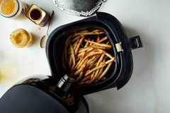 FILE Ñ A batch of French fries in an air fryer in New York in October 2018. Though air fryers are sold as a way to make foods crunchy without deep-frying, home cooks have put them to countless other uses Ñ and fed a billion-dollar business. Food styled by Simon Andrews. (David Malosh/The New York Times) ORG XMIT: XNYT153