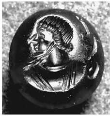 Figure 13. Early Sogdian coin. Portrait of a ruler, second-—first centuries BC (?). Figure 12. Samarkand Museum. Engraved gem (cornelian), first century BC-first-second centuries AD. Portrait of a governor. Literary sources recount how the Yuezhi on their long journey from the valley of Gansu met different peoples. The first were the Wusun. After their defeat by the Wusun in the region of Semirech’e, the Yuezhi migrated further in a westerly direction. Passing through Da Yuan, they reached the region between the two rivers of Amu Darya and Syr Darya. Here, north of the Oxus River, they found another tribe already settled for some time, whom we can hypothetically identify as the Sakaraules.